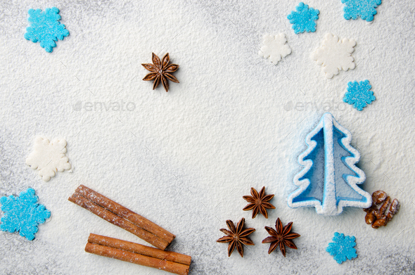 Christmas kitchen background made of flour, cinnamon sticks, anise,  cookie cutter - Stock Photo - Images
