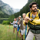 Group of happy hiker friends trekking as part of healthy lifestyle outdoors  activity Stock Photo by nd3000