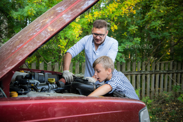 The father and son checking the car engine