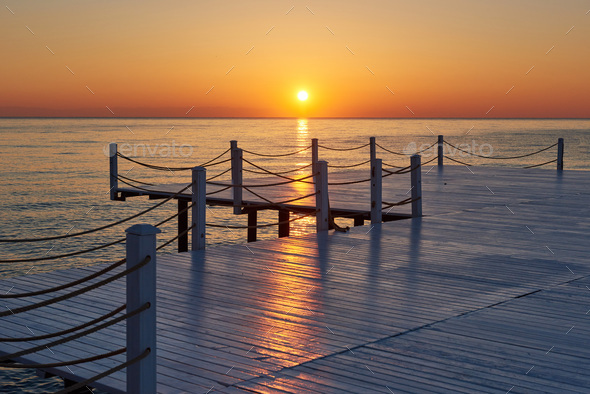 Wooden pier on a fancy orange sunset - Stock Photo - Images