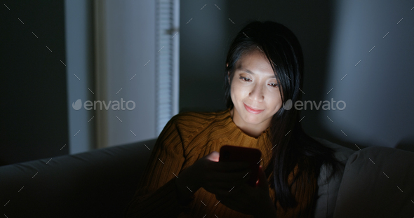 Woman use of mobile phone at night - Stock Photo - Images