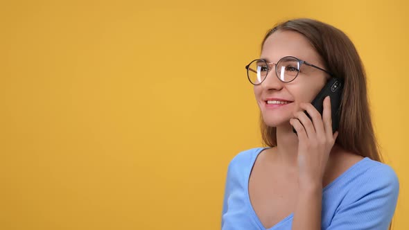 Closeup Blonde Woman in Eyeglasses Smiling Talking Smartphone Gesticulating with Positive Emotion alt
