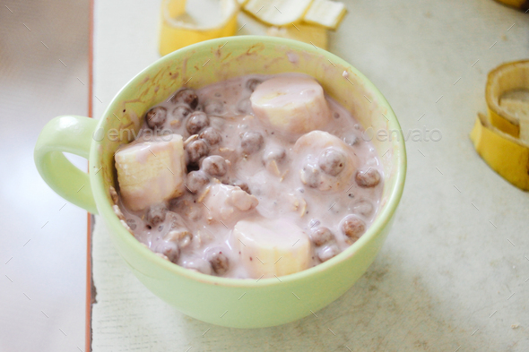 morning breakfast bananas yogurt cereals in bowl on old rustic table - Stock Photo - Images