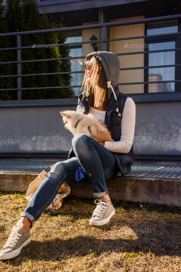 Casual girl with small dog - Stock Photo - Images