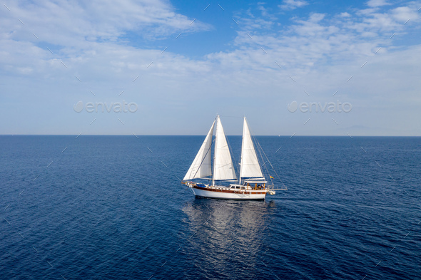 Sailing Boat With White Sails In The Open Sea Cloudy Blue Sky Stock