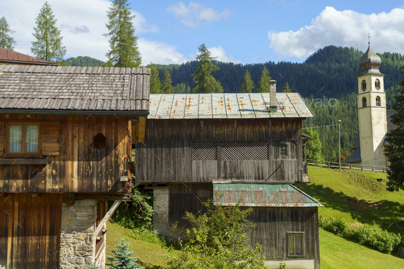 Mountain landscape at summer along the road to Forcella Staulanza at Selva di Cadore, Dolomites, Belluno province, Veneto, Italy. Typical wooden house