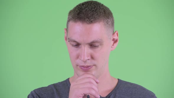 Face of Stressed Young Man Thinking and Looking Down alt