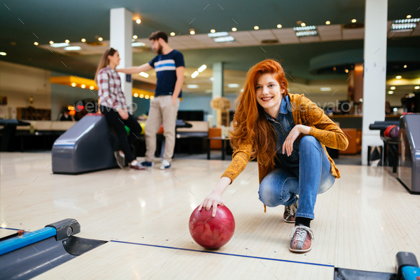 Competitve people enjoying bowling