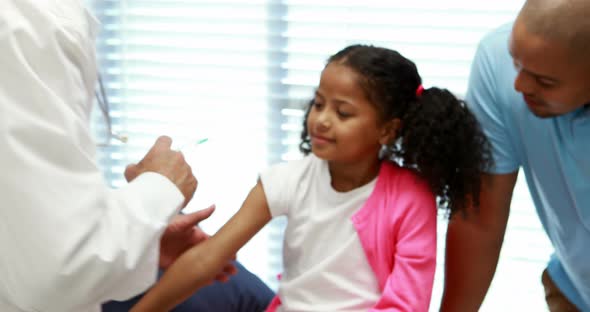 Male doctor giving an injection to the patient alt