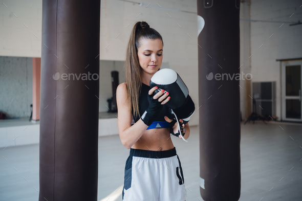 A Young Athlete Is Preparing For Boxing Training With Punching Bags In The Gym During The Day Stock Photo By Romankosolapov