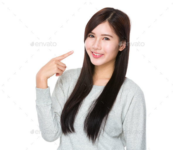 Asian Young woman with finger point to her teeth