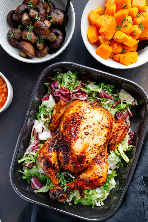 Download Top View Of A Whole Roasted Chicken Served With Fresh Salad In Black Pan Stock Photo By Edalin