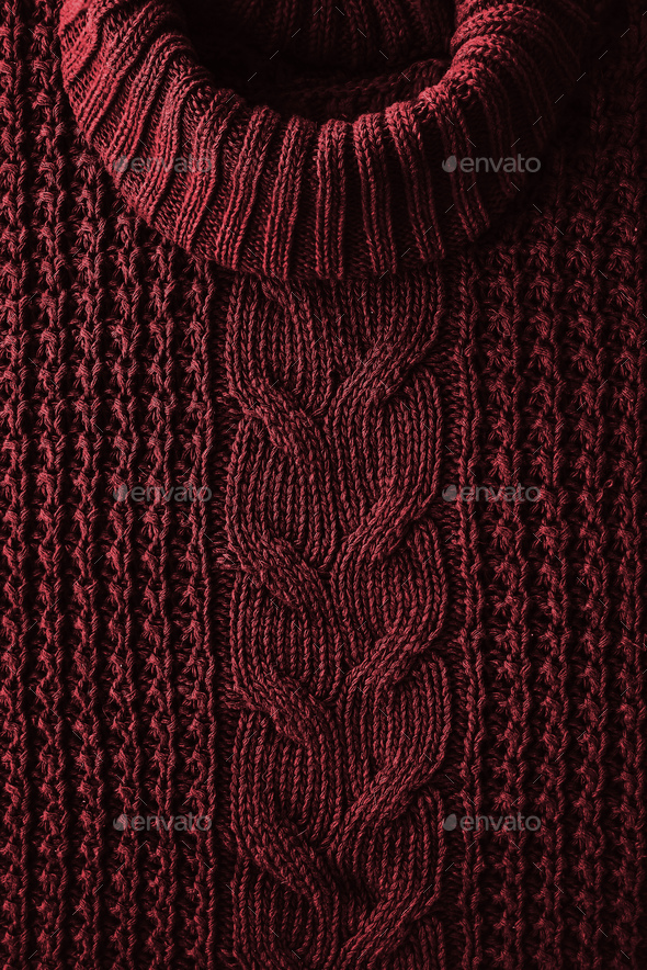 Knitted texture background of a winter red sweater with a high neck. Hipset style