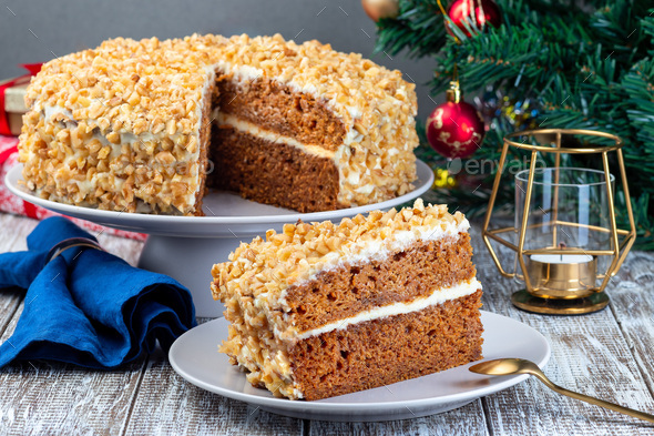 Piece of Carrot cake with cream cheese frosting and walnuts