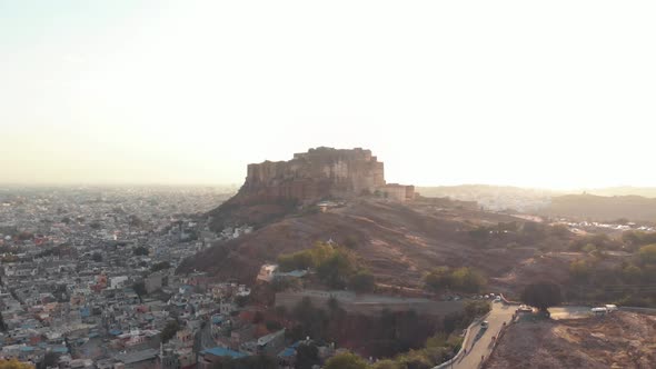 Mehrangarh Fort contrasting with golden sunset at the foothill of the border of Jodhpur, India alt