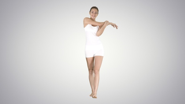 Contented happy young woman stretching her arms while walking alt