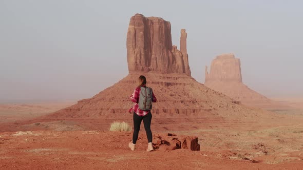 Cinematic Female Traveler Walking in Scenic Red Desert Park Landscape View alt