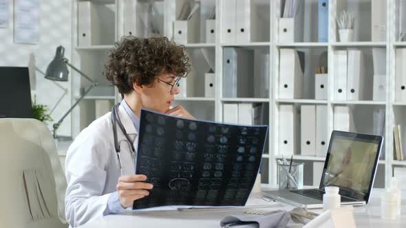 Doctor Discussing X-ray Image with Online Patient alt