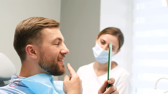 A Visit to the Dentist the Patient Looking in the Mirror and Shows a Diseased Tooth alt