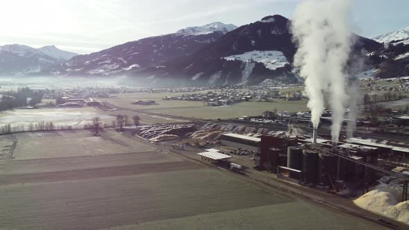 Wood Sawmill Proccessing Wood Logs and Manufacturing Wooden Cuts and Chimneys Smoke is Polluting the