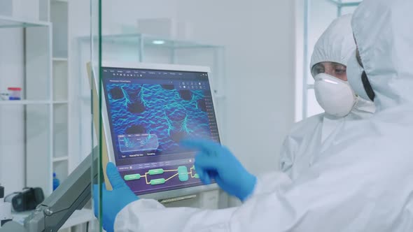 Biochemists in Coverall Typing on Digital Display Vaccine Composition alt