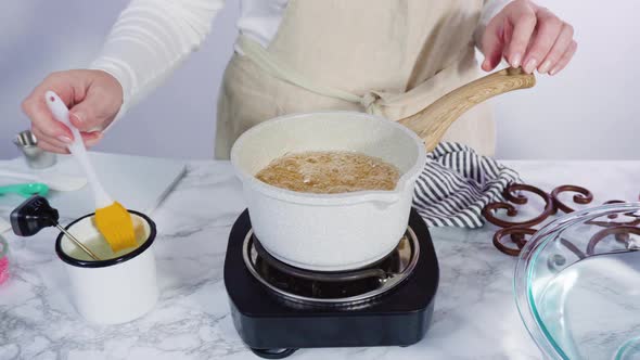 Step by step. Caramelizing sugar in a small cooking pot over the small electric stove alt