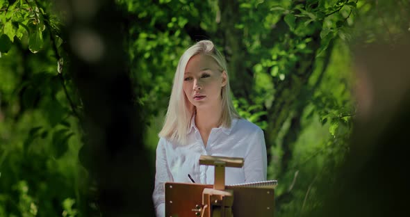 Beautiful Girl Enthusiastically Draws in Nature the Process of Creating a Picture alt