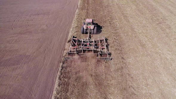 Agricultural Tractor Cultivating Field alt