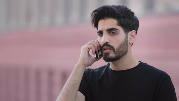 Angry Stressed Bearded Indian Male Businessman Disputing on Phone with Partner alt