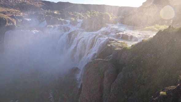 Wide panning view of Shoshone Falls as mist blows alt