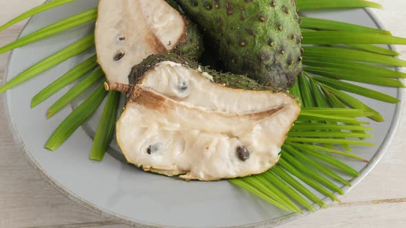 Closeup of Green Soursop Graviola, Exotic, Tropical Fruit Guanabana on Plate alt
