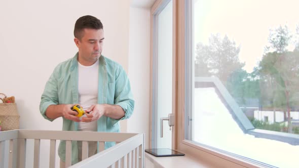 Father with Tablet Pc and Ruler Measuring Baby Bed 12 alt