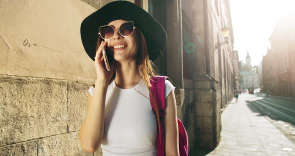 Tourist Woman Talking on Smartphone in City