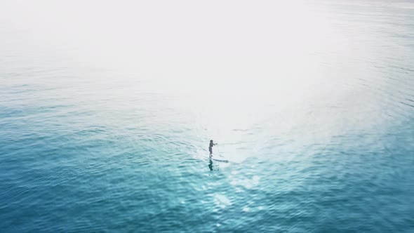 View From The Height On A Lonely Surfer Relaxing In The Calm Waters