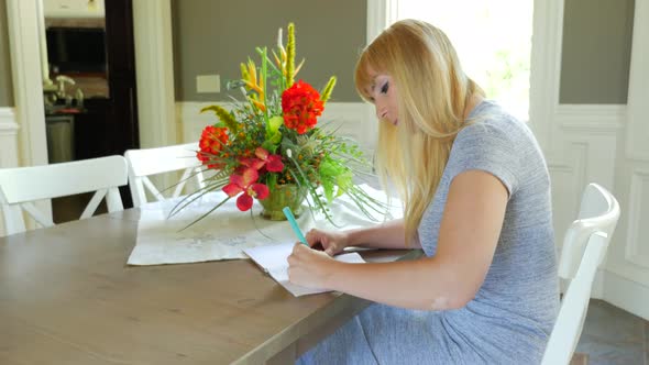 Attractive Female In Dining Room Writing In Her Journal 04