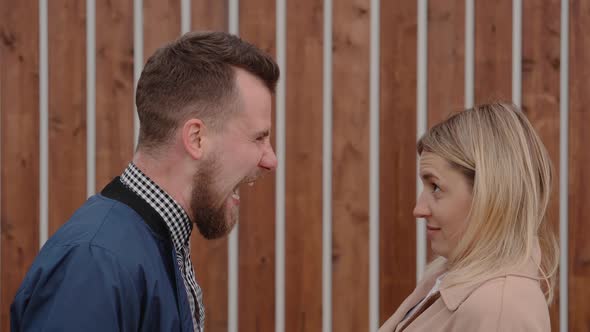 Furious Man Is Shouting on Blonde Woman and She Is Crying Outdoors Medium Shot alt