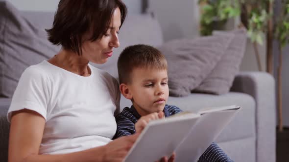 Mother Reading Book with Son