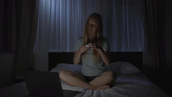 A Woman at Night Turns on a Meditation Relaxation Application on Her Computer to Relax Before Going alt