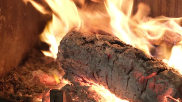 Firewood is Burning in a Cozy Fireplace alt