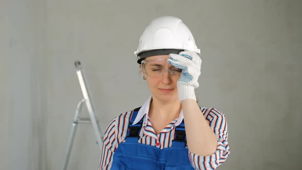 Repairwoman with a Puncher Doing Home Renovation alt