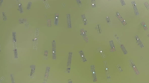 Aerial view of local fishing trap net in canel with fisherman home, lake or river at sunset. Nature alt