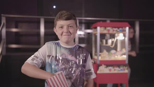 Young Boy Munching Pop Corn Happily - Ungraded alt