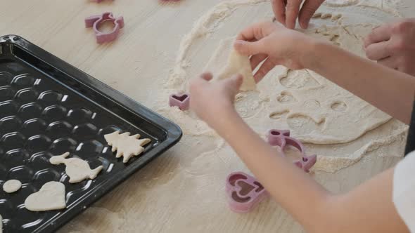 Little Girl Putting Raw Cookies on Baking Sheet alt