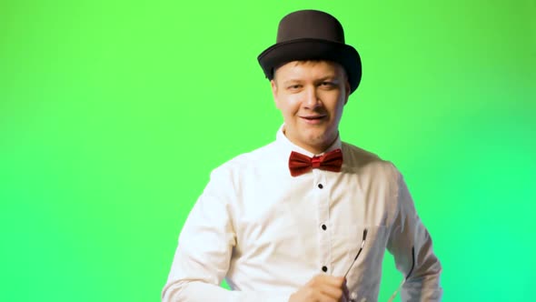 Young Man in a Hat and Bowtie Glasses Happy Performer Chromakey