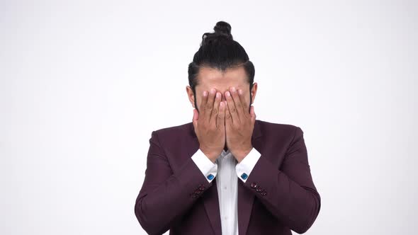 Scared Indian businessman peeking alt