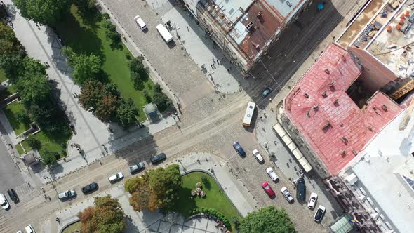 Aerial topdown of cars driving on the road in Lviv Ukraine during a sunny summer day surrounded by o alt