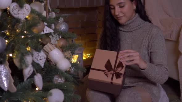 The Girl Opens a Gift on New Year's Eve alt