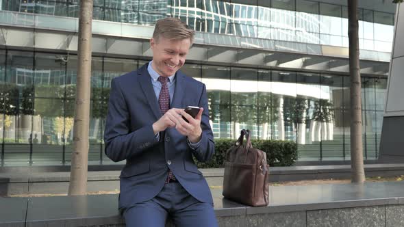 Happy Businessman Using Smartphone for Reading Email alt