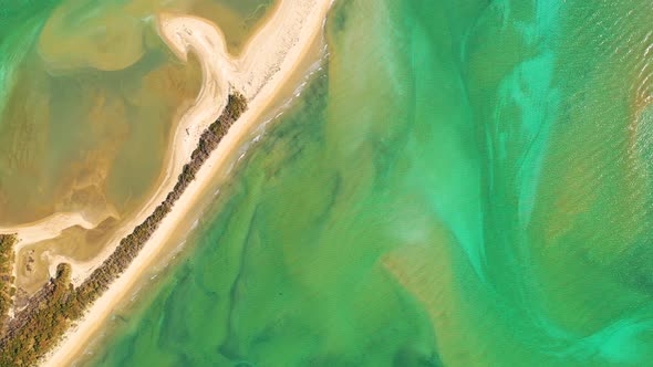 Aerial view of sandbank natural barrier at Takapou Bay, New Zealand. alt