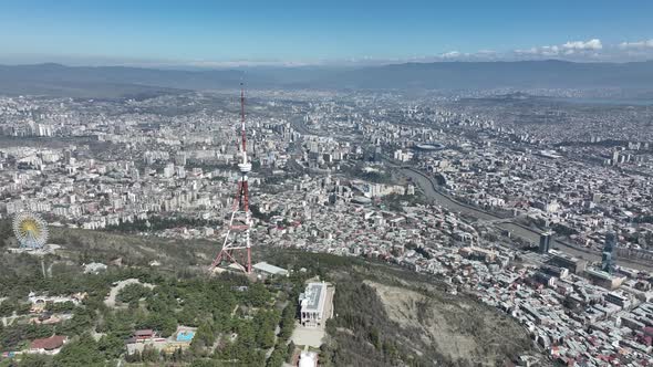 Aerial view of TV Tower in Mtatsminda park. Against the background of the city. Tbilisi, Georgia alt